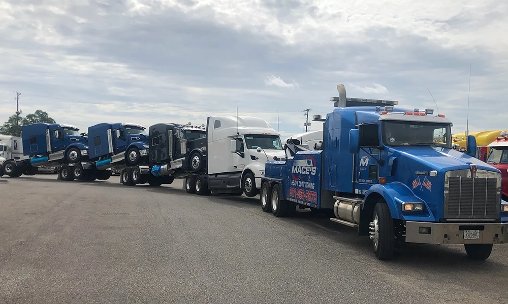 Mace's heavy duty tow truck towing multiple trailer rigs