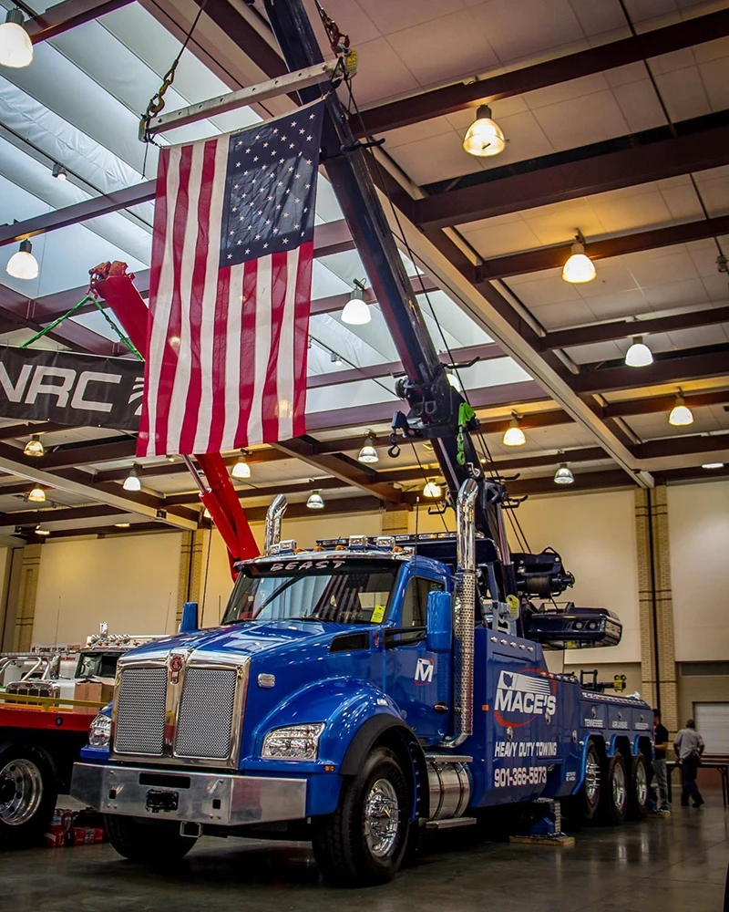 Mace's heavy duty tow truck with American flag above